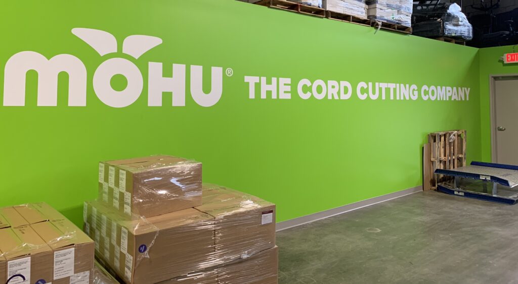 Mohu warehouse, green walls with "mohu The Cord Cutting Company"