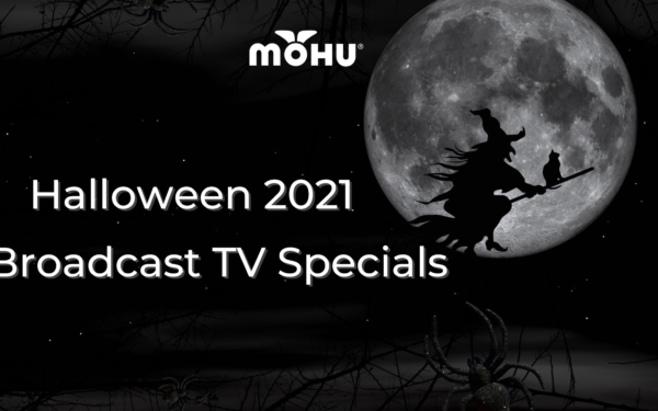 Witch riding a broom across the moon in the dark night sky. Mohu Logo. Halloween 2021 Broadcast TV Specials
